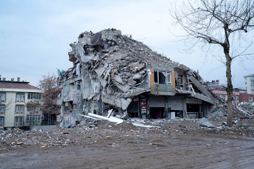 Collapsed building in urban landscape showing earthquake devastation and debris.