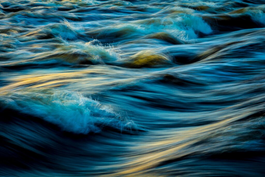 Capture of flowing ocean waves in motion, showcasing the vibrant colors and dynamic movement of water. FND Aware